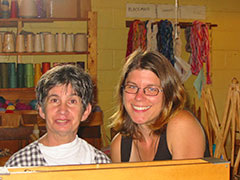 With a smile as wide as the community she has uncovered, Innisfree volunteer Lisa Gerlits (she's on the right) takes a break with a participant while working in the weavery shop.