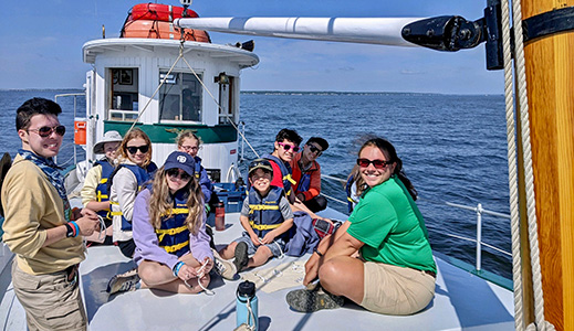 Staff training involves field trips, lectures, sailing, emergency drills, games, and teaching practice.